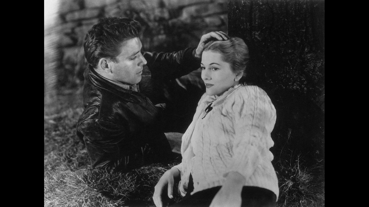 Burt Lancaster caresses Fontaine's head in the 1948 film "Kiss the Blood Off My Hands."