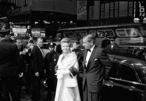 Fontaine, escorted by Charles Addams, arrives at the Rivoli Theater in 1963 for the world premiere of the film "Cleopatra" in New York.