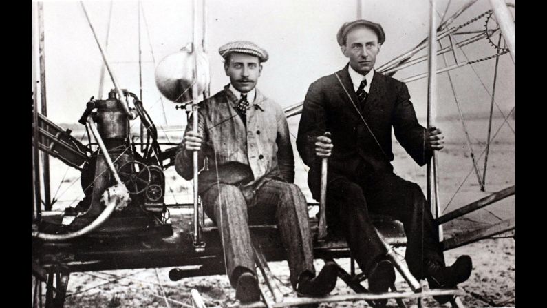In the early 1910s, Wilbur Wright and balloonist Ernest Zens sit in the Wright Model A Flyer at Camp d'Auvours, France.