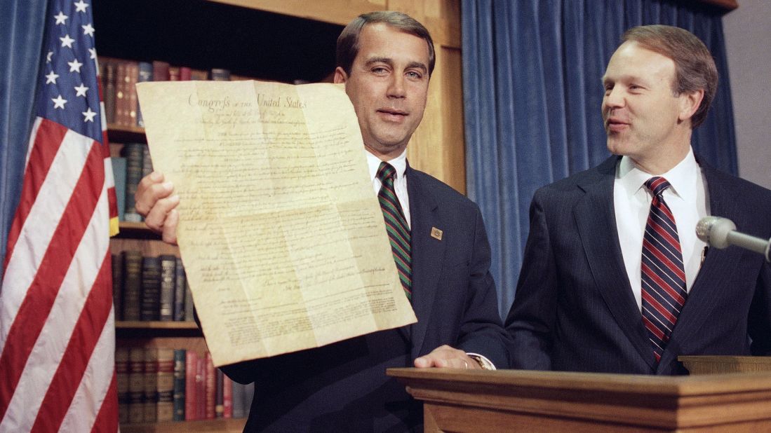 Boehner, R-Ohio, holds a copy of the Constitution on Capitol Hill in Washington on May 7, 1992, as Sen. Don Nickles, D-Oklahoma, looks on. Both men proclaimed it was a historic day when the Michigan House ratified the 27th Amendment to the Constitution, which would require that any Congressional pay raises not go into effect until after the next election. 