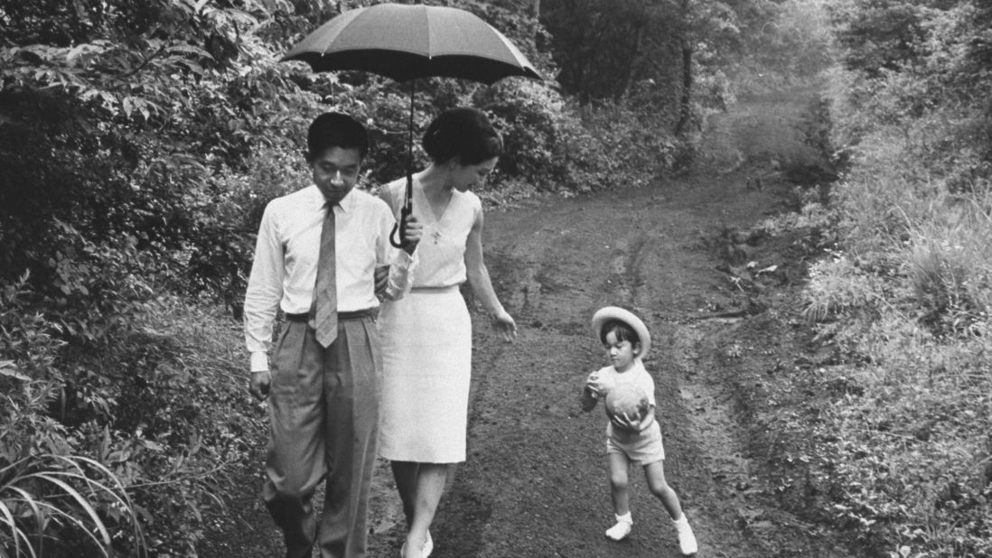 Prince Akihito takes a walk with Princess Michiko and their son Naruhito in 1964. 