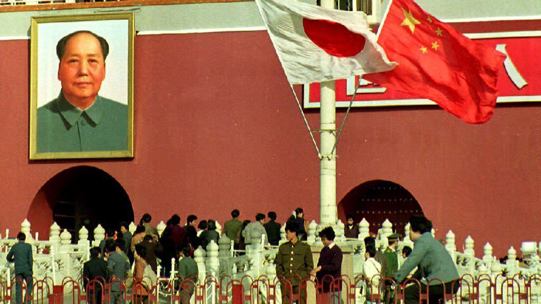 Visitors to China's Forbidden City walk beneath Japanese and Chinese flags, flown to welcome Emperor Akihito on October 23,1992. Akihito's visit to China was the first ever by a Japanese emperor.