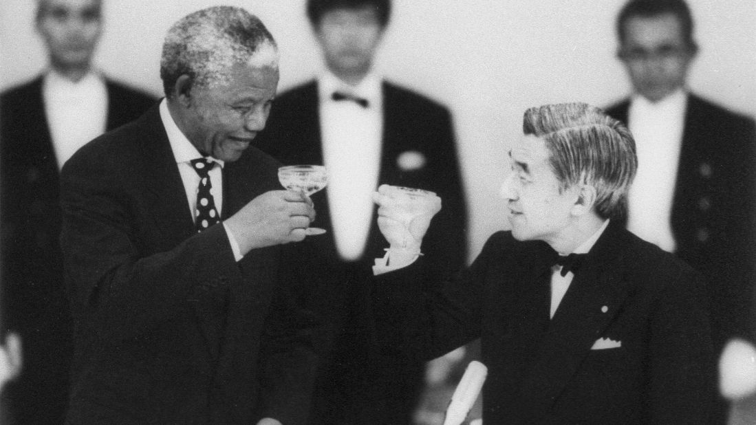 South African President Nelson Mandela and Emperor Akihito toast during a banquet at the Imperial Palace in Tokyo in July 1995. 