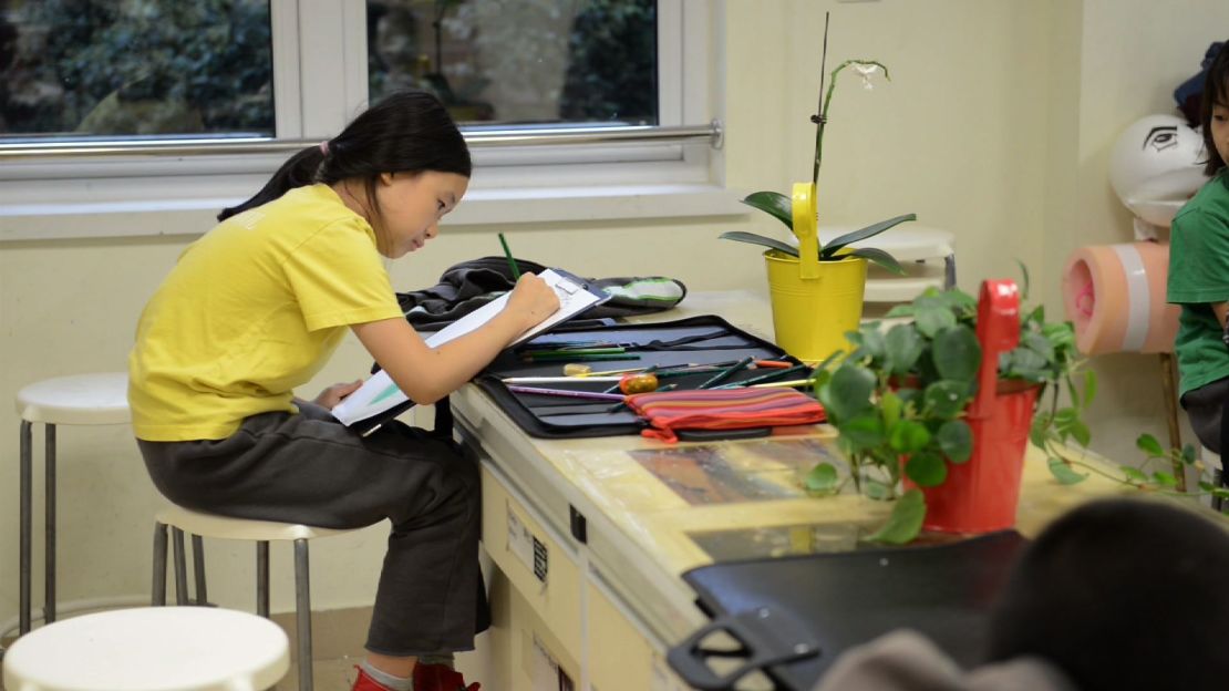 Girl does homework at Y. K. Pao School in Shanghai