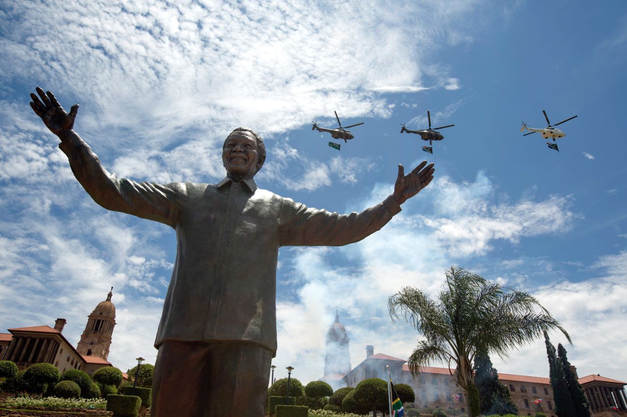 DECEMBER 17 - PRETORIA, SOUTH AFRICA : A military fly-past takes place above a statue of <a href="http://www.cnn.com/SPECIALS/africa/nelson-mandela/index.html">former South African president Nelson Mandela</a>. The statue's unveiling at the Union Buildings in Pretoria marked the end of 10 days of mourning -- and celebrating -- the nation's anti-apartheid hero. Nelson Mandela died surrounded by his family on Thursday, December 5.