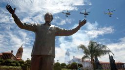PRETORIA, SOUTH AFRICA - DECEMBER 16: A military fly-past takes place above a statue of former South African president Nelson Mandela shortly after its unveiling at the Union Buildings on December 16, 2013 in Pretoria, South Africa. South African president Jacob Zuma unveiled a 9 meter bronze statue of former South African president Nelson Mandela as part of the Day of Reconciliation celebrations. (Photo by Oli Scarff/Getty Images)