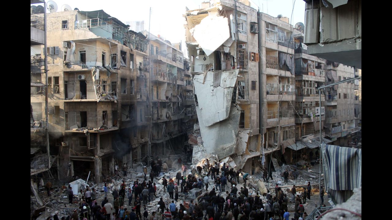 People search for survivors amid the rubble after an airstrike in Aleppo on Tuesday, December 17. 
