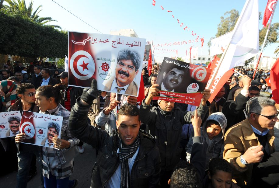 Tunisians carry portraits of assassinated opposition figure <a href="http://cnn.com/2013/07/25/world/africa/tunisia-politician-killed/index.html">Mohamed Brahmi.</a>