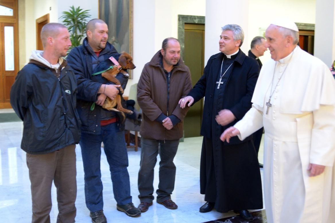 Pope Francis marked his 77th birthday on December 17 by hosting homeless men to a Mass and a meal at the Vatican. One of the men brought his dog. 