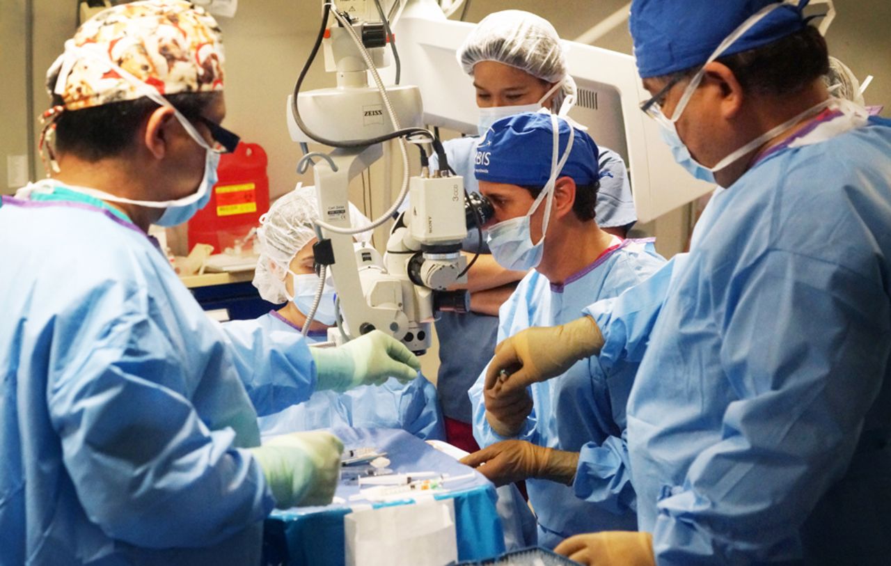Flanked by his fellow Panamanian physicians and support nurse staff, Dr Ernesto Otero performs a teaching case in the plane's operating room.