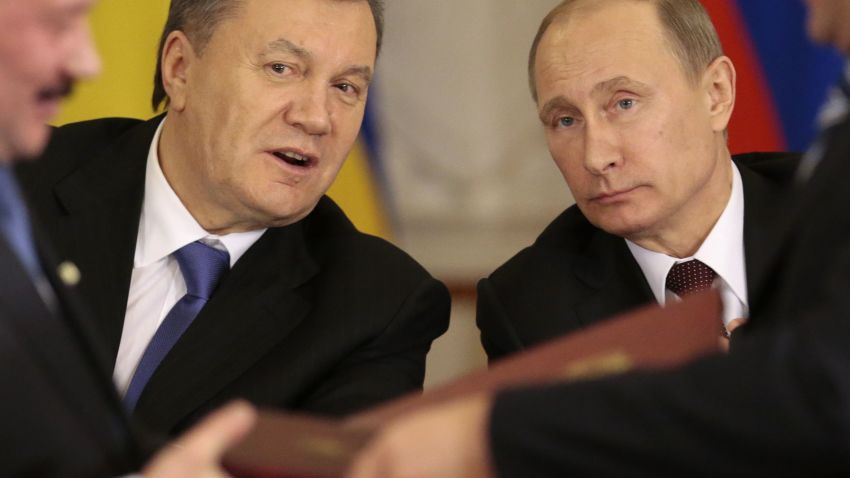 Russian President Vladimir Putin, right, and his Ukrainian counterpart Viktor Yanukovych, left, react after signing an agreement in Moscow on Tuesday, Dec. 17, 2013.