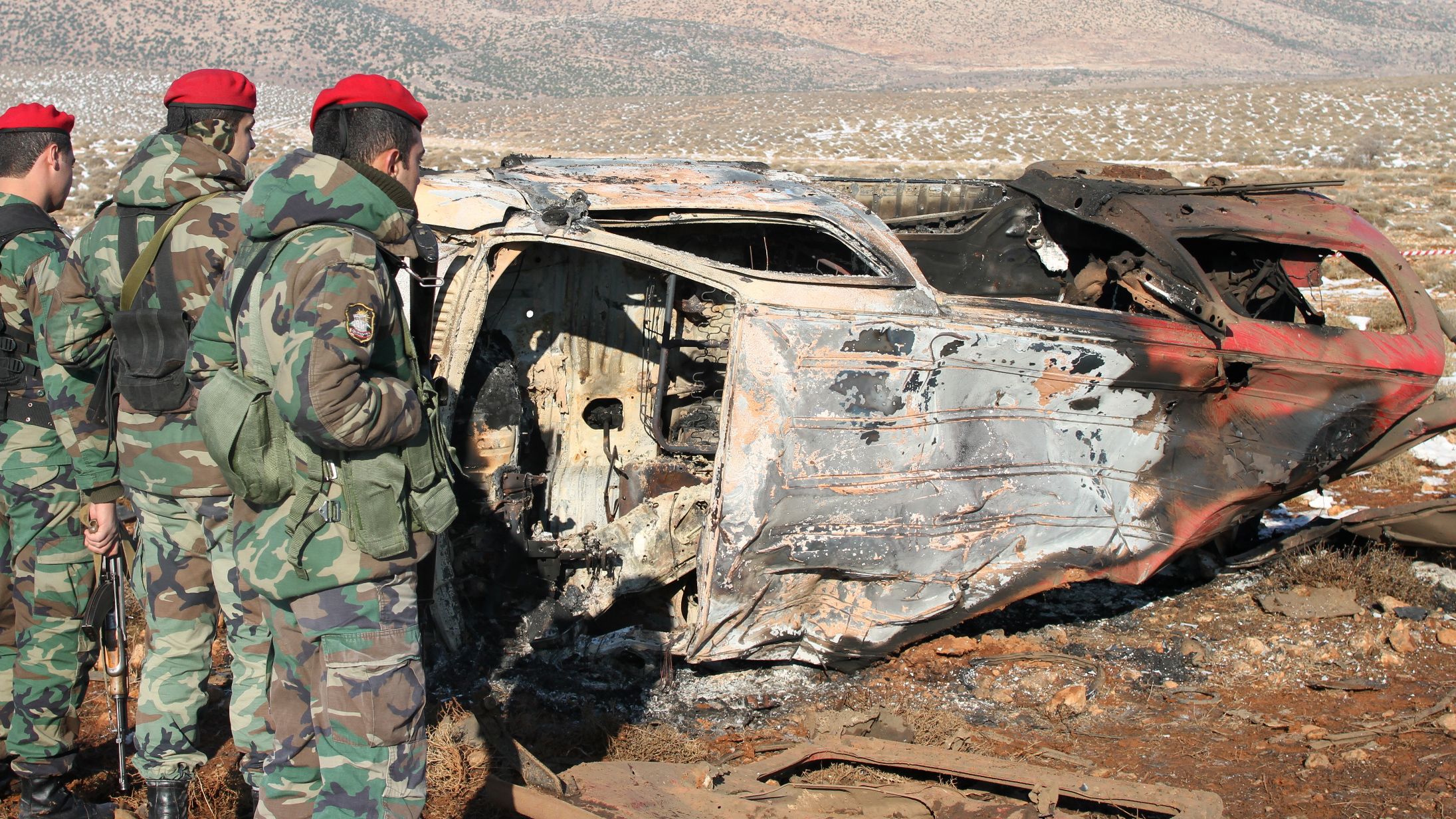 Lebanese soldiers stand next to the wreckage of a van following an explosion in the Bekaa valley on December 17.