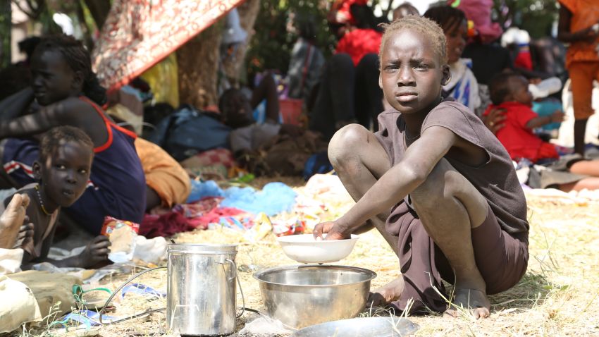 A girl displaced following recent fightings in the capital prepare a lunch inside the UNMISS compound, on December 17, 2013 on the outskirts of Juba.