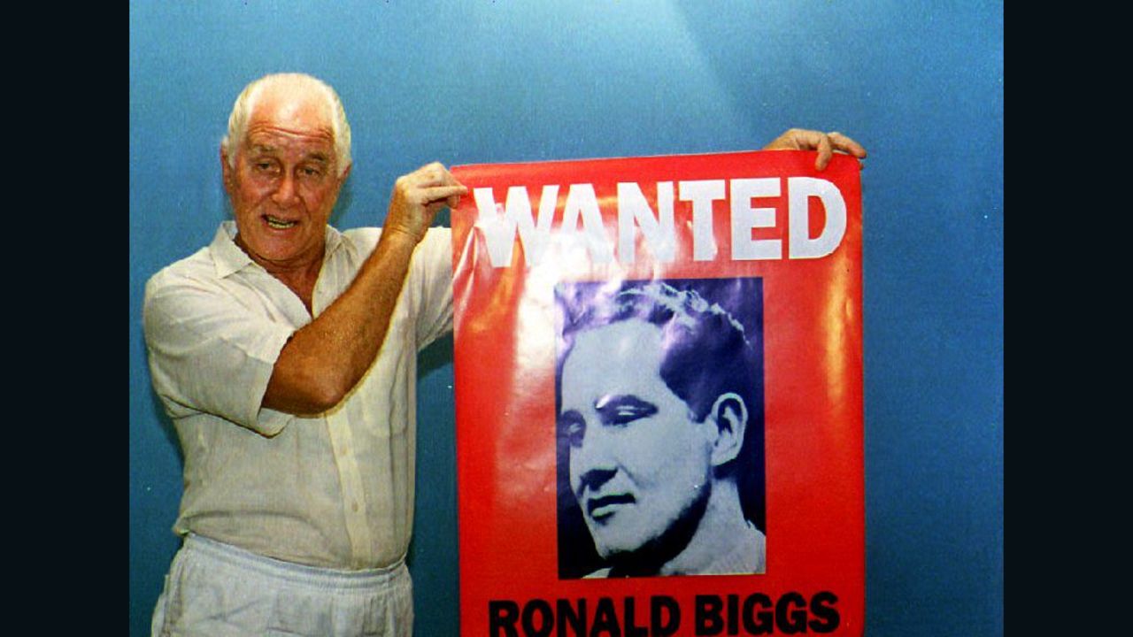FILE: Ronnie Biggs holds up a poster of himself during the promotion of his book "Odd Man Out" on January 21, 1994 in Rio de Janeiro.