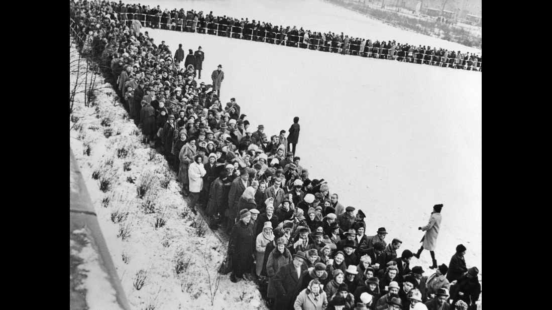 Thousands of people line up December 19, 1963, to apply for passage into East Berlin. An estimated 2 million residents of West Berlin applied for holiday passes to East Berlin, and about half were able to receive one.