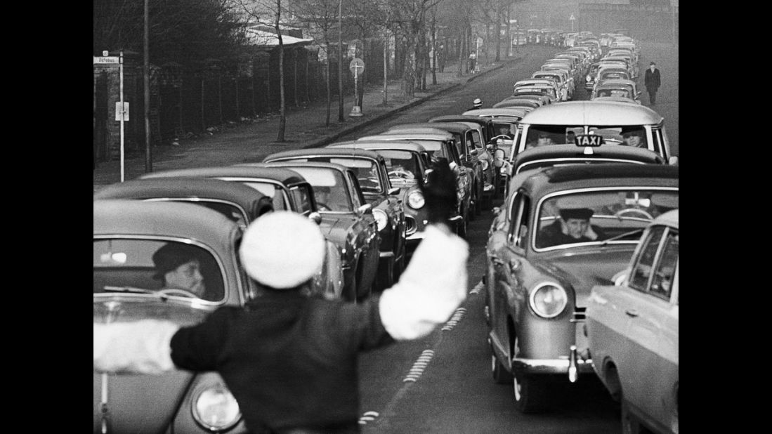 A West Berlin policeman stops traffic at an crossing point on January 5, 1964. It was the last day West Berliners could visit East Berlin with a permit, although similar holiday openings would take place during the 1960s.