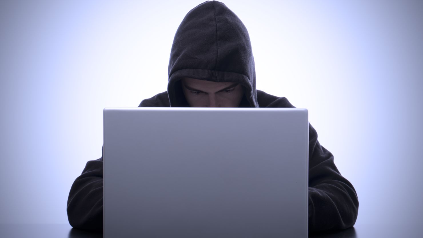 With big data comes big responsibility. Above, a computer hacker types on his laptop representing the ominous future of data protection and security. 