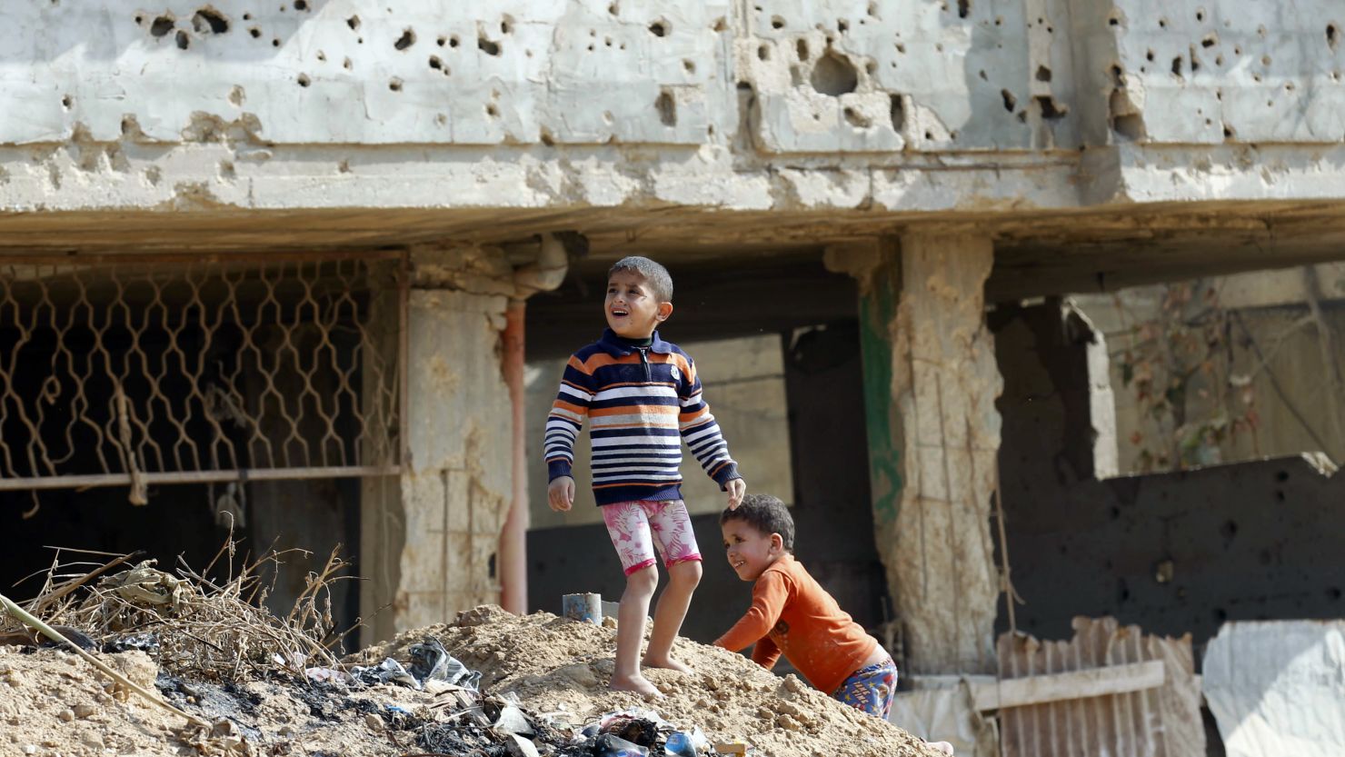 Palestinian children play in front of a house in Gaza in November that was damaged in an Israeli army operation in 2012.