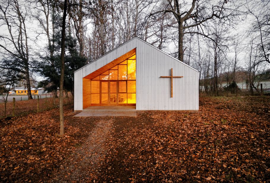 The pine wood interior of this one-room chapel in rural Chile emanates a warm glow, a striking contrast against the gray aluminium exterior. Designed by Baladron & Grass.