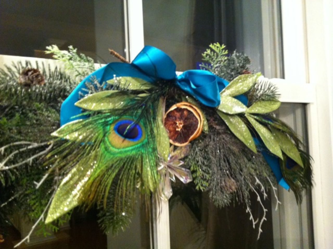 Peacock feathers and cut pine and cedar helped Norwood focus her holiday decor on blues and greens.