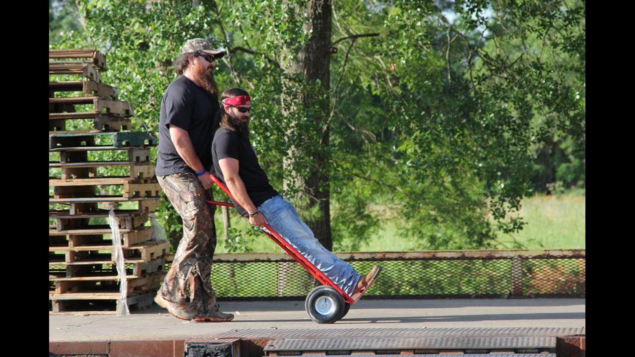 Jep Robertson, one of Willie's brothers and Phil's sons, is pushed along by Duck Commander employee Justin Martin.