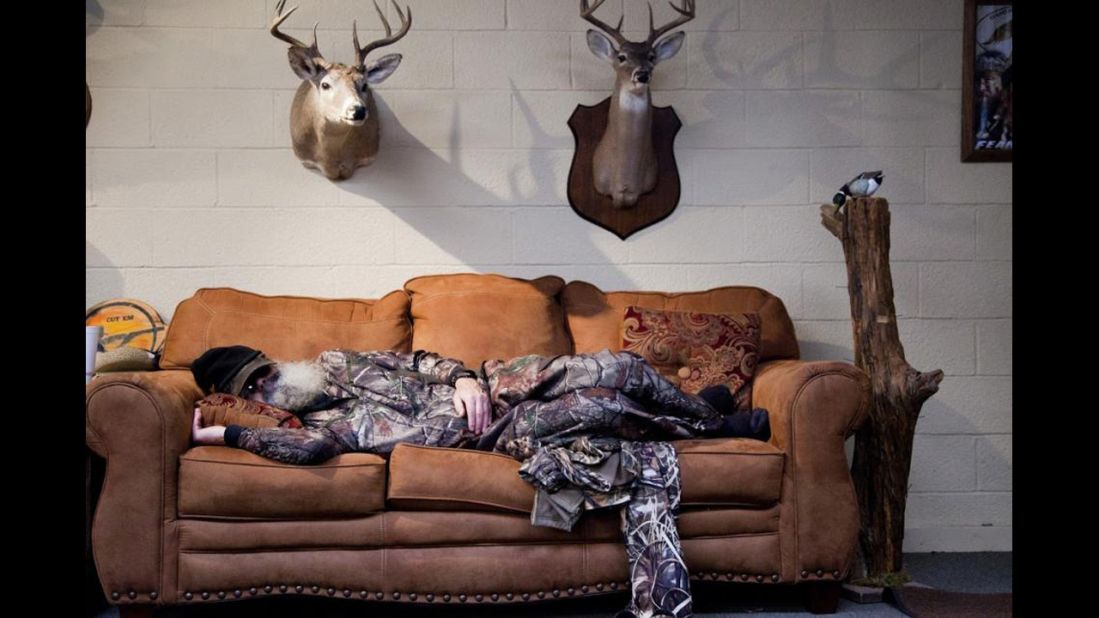 Si takes one of his daily naps, surrounded by some Robertson family trophies.