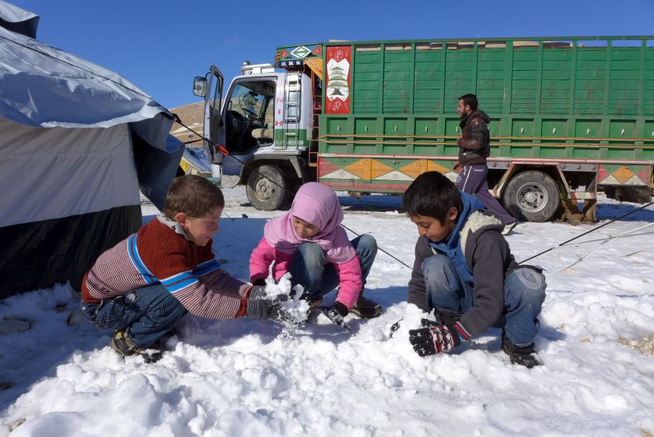Syrian refugees play in the snow at the Shuhada Camp in Arsal, Lebanon on December 16. Impoverished Syrian refugees throughout the Middle East are facing harsh winter weather.