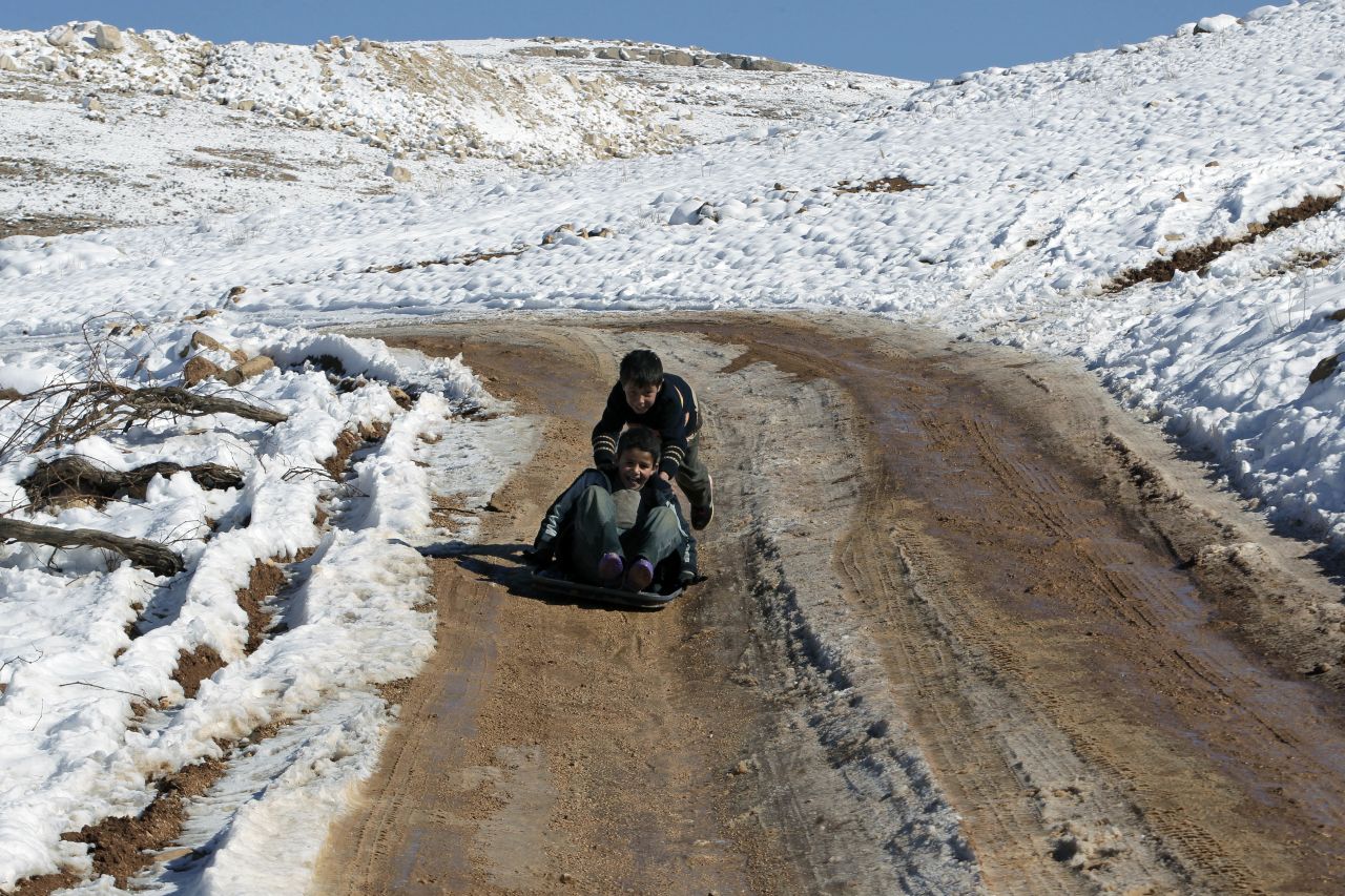 Children play in the snow at a refugee camp in Arsal on December 15.