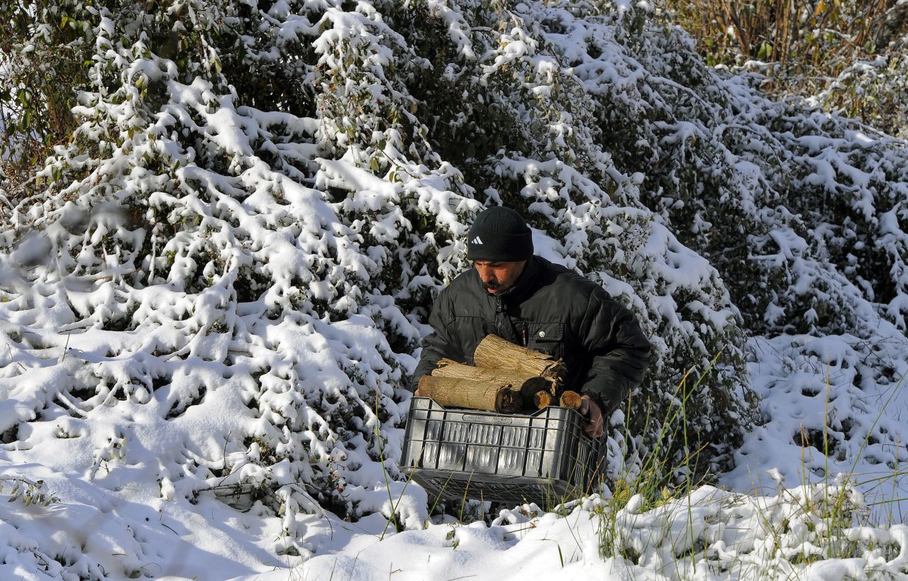 A Syrian refugee carries firewood in the Lebanese village of Hammana.