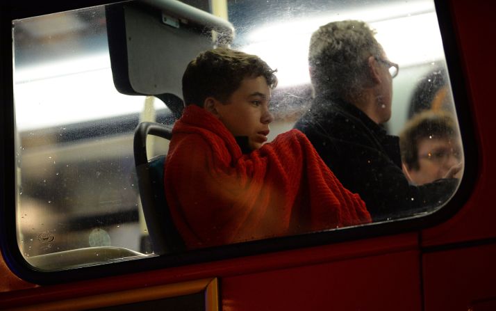 People sit aboard a bus used to hold theatergoers.