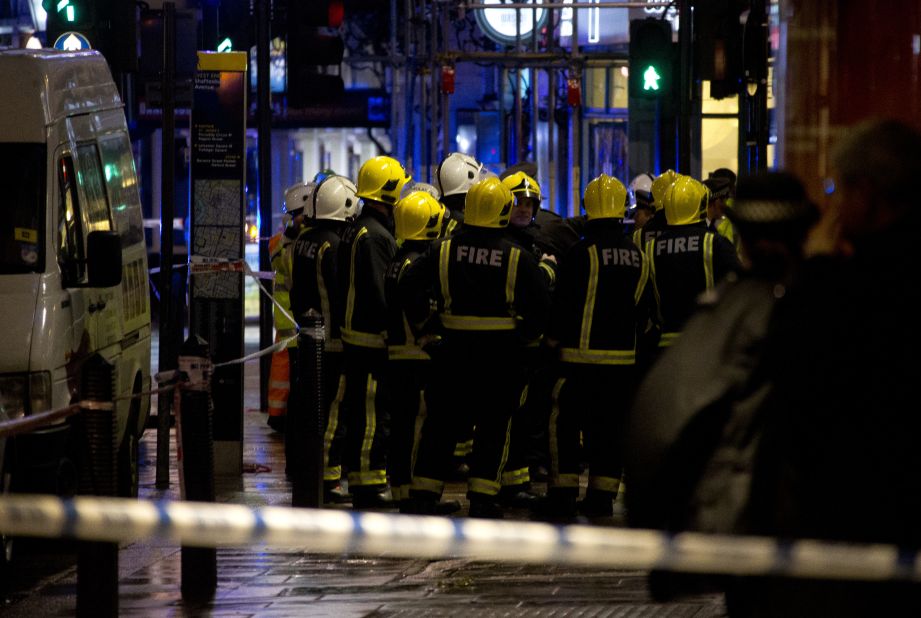 Firefighters confer at the scene. Nick Harding, the London Fire Brigade's Kingsland Station manager, said about 720 people were inside the theater when a section of the ceiling collapsed, taking parts of the balconies with it.