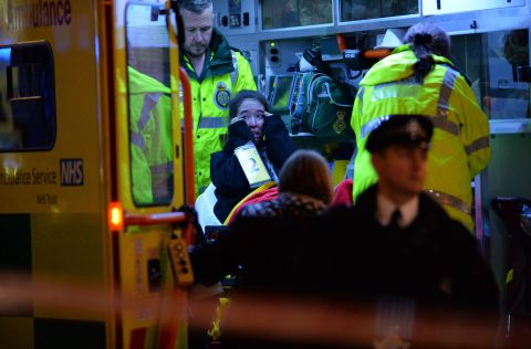 An injured woman cries inside an ambulance.