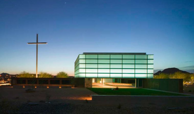 Effortlessly opening to the surrounding desert, the innovative 250-seat glass and steel prayer chapel sits atop four site-cast, pin-wheeling concrete walls. The double-skinned Pavilion  of Light is composed of shading and insulating systems. 