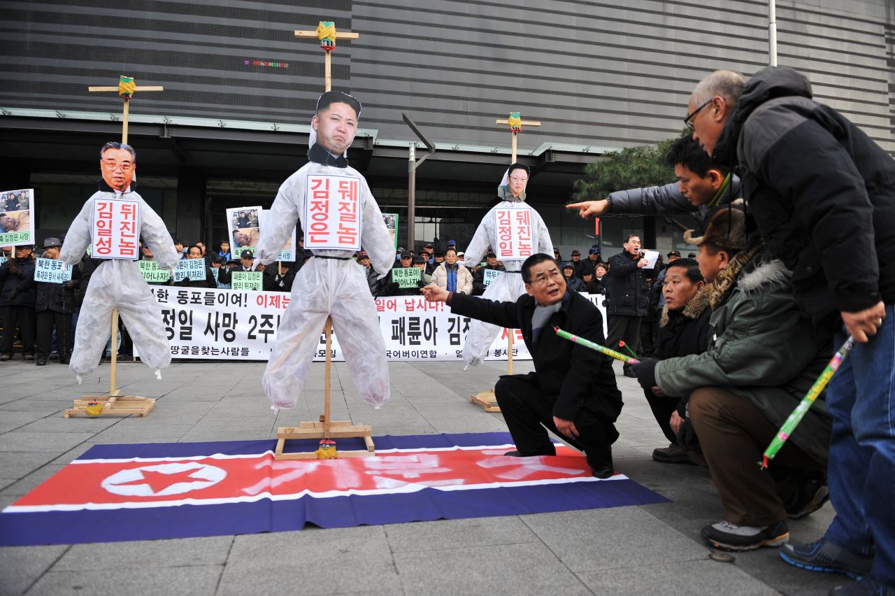 Activists prepare to light effigies of North Korean leaders during a protest in Seoul.