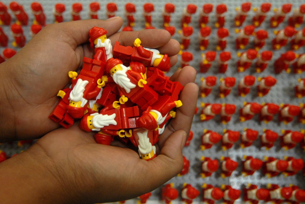 Women organize thousands of Lego Santa Clauses on Wednesday, December 18, in Surabaya, Indonesia.  