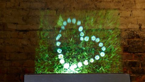 According to Displair the image is created inside a layer of "dry fog which is composed of ultra-fine water droplets."