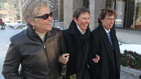Plaintiffs Laurie Wood, left, and Kody Partridge, center, walk with attorney Peggy Tomsic on December 4, 2013, after a judge heard arguments challenging Utah's same-sex marriage ban.