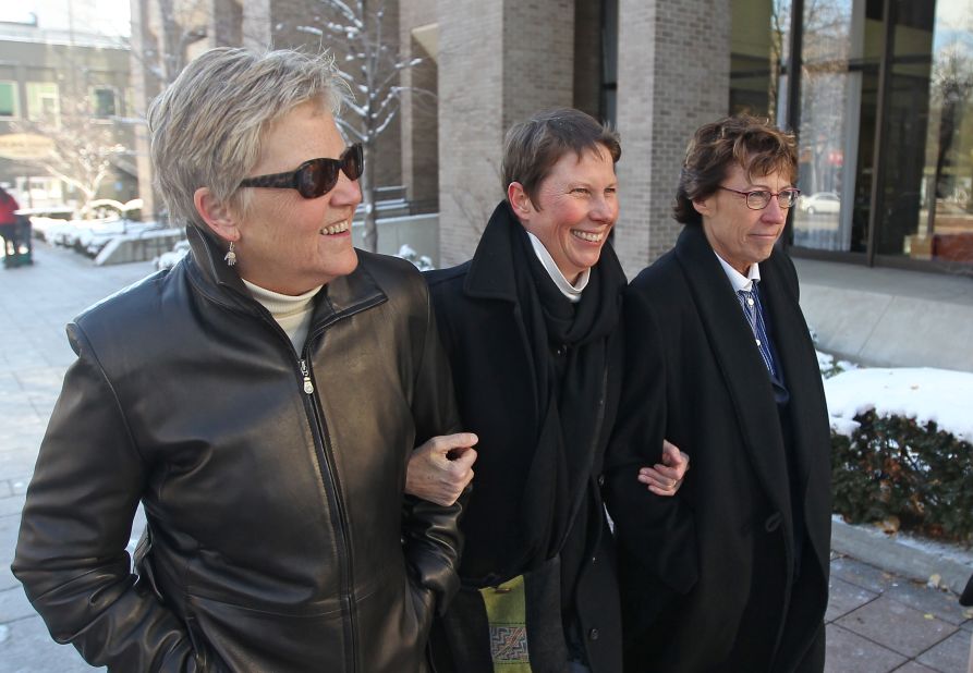 Plaintiffs Laurie Wood, left, and Kody Partridge, center, walk with attorney Peggy Tomsic on December 4, 2013, after a judge heard arguments challenging Utah's same-sex marriage ban.