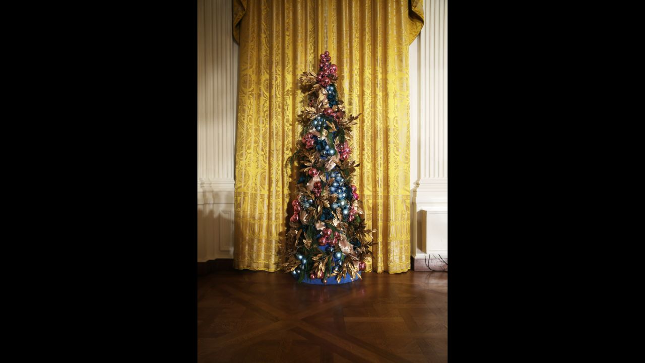 A Christmas tree stands in the East Room of the White House on Wednesday, December 4. First lady Michelle Obama hosted military families for the first viewing of the 2013 holiday decorations and demonstrated holiday crafts and treats to military children.