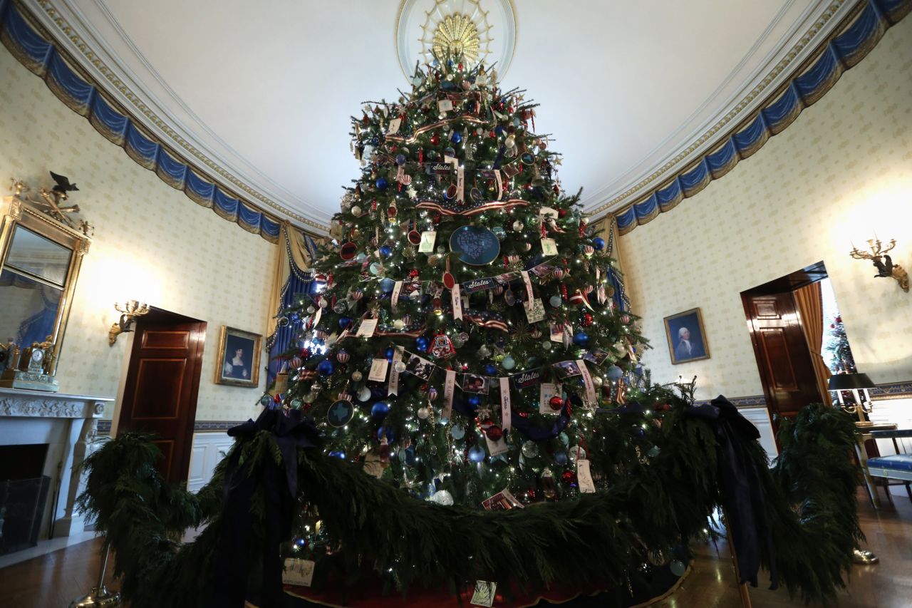 The official White House Christmas Tree stands in the Blue Room of the White House during an event to preview the 2013 holiday decorations on December 4.