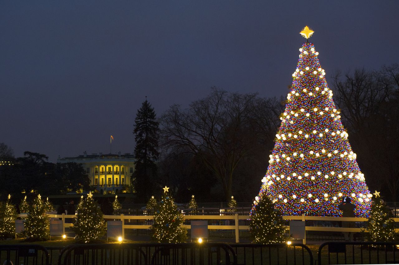 The "Pathway of Peace," 56 small, decorated trees representing all 50 states, five territories, and the District of Columbia surround the National Christmas Tree on the Elipse in front of the White House on Monday, December 9.