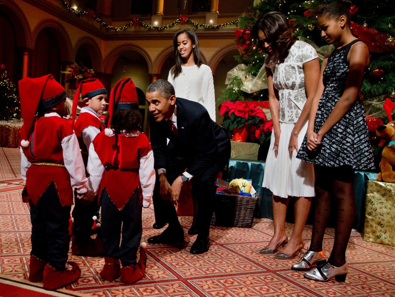 The Obamas greet children dressed like elves at the National Building Museum in Washington on Sunday, December 15.