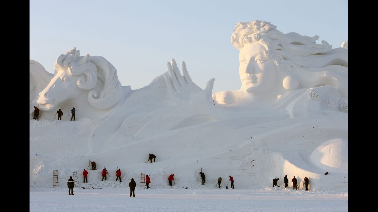 <strong>December 20: </strong>Workers carve a 117-meter-long, 26-meter-high snow sculpture at the Sun Island Park during the 26th China Harbin International Snow Sculpture Art Expo in Harbin, Heilongjiang province, China.