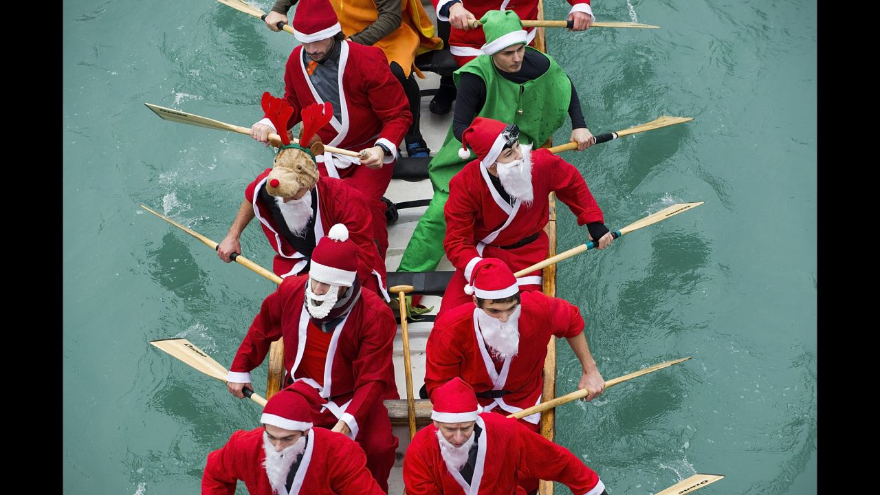 Rowers dressed in Santa Claus costumes take part in the Christmas Regatta on the Grand Canal on Saturday, December 21, in Venice, Italy.