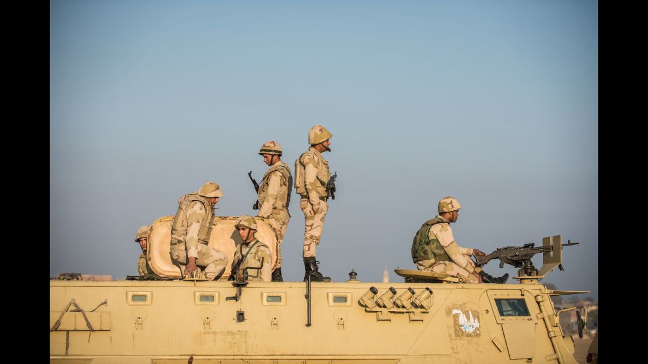 <strong>December 21: </strong>At sunrise, Egyptian soldiers stand guard outside the temple of Qasr Qarun in Fayoum province, Egypt.