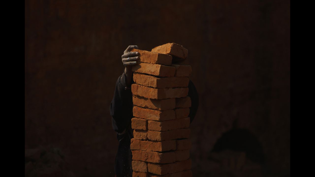 <strong>December 20: </strong>A man stacks bricks at a brick factory in Lalitpur, Nepal.