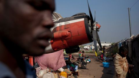 Displaced people sit with their belongings at a makeshift camp housing thousands in Bangui on Saturday, December 21.