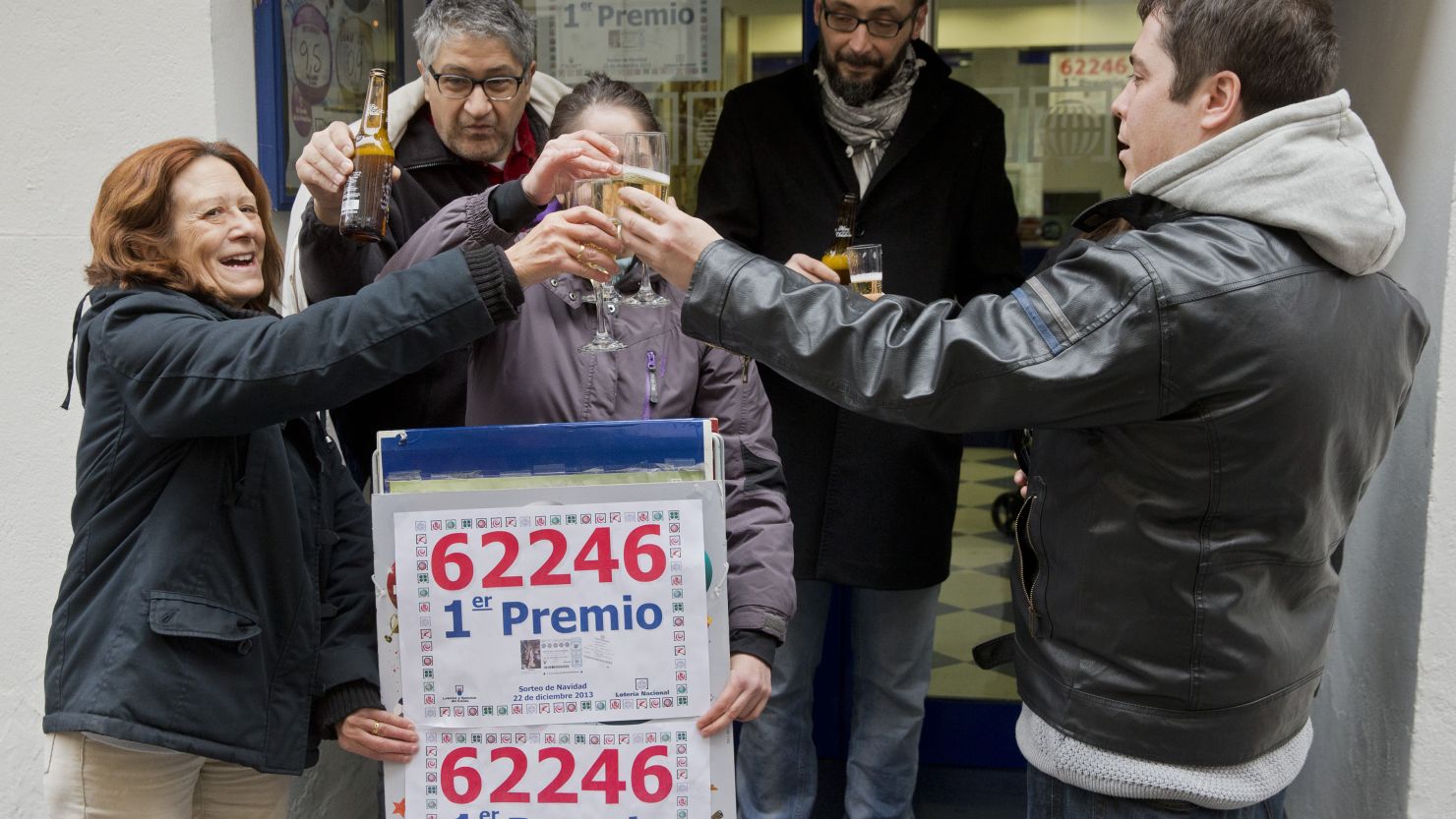 Lottery Administration owners and locals celebrate having sold a first prize ticket in Spain's Christmas lottery named "El Gordo" (Fat One) in Palencia on December 22, 2013.