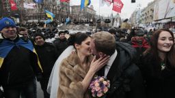 Newlyweds Mikhail and Margarita Nakonechniy kiss in front of barricades on Independence Square in a gesture of support for pro-Europe activists in Kiev, Ukraine, on Saturday, December 21.