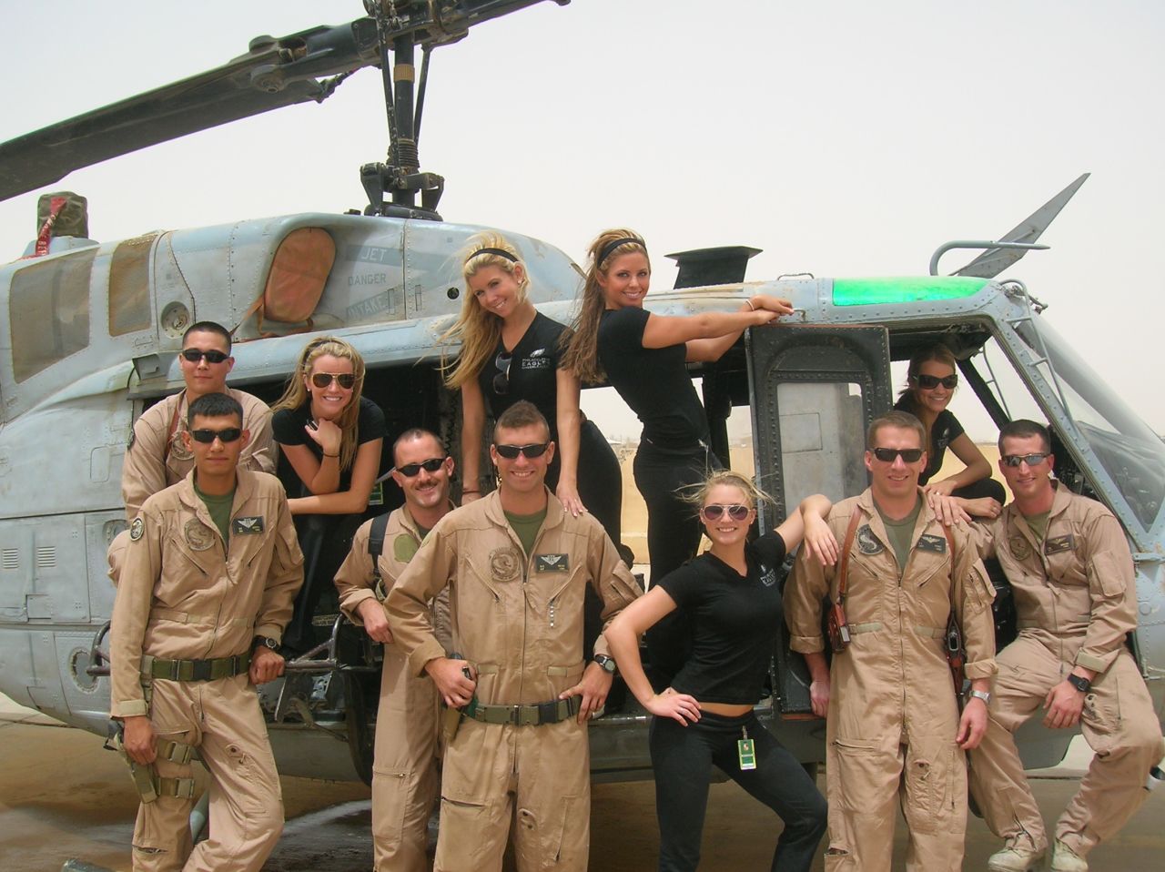 Washburn, standing at right in helicopter door, is seen on a Philadelphia Eagles goodwill tour of military units in Iraq. 